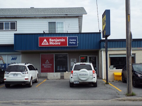 Gatineau, Quebec, Canada &ndash; July 02, 2026: A commercial storefront displays "Benjamin Moore Centre Farley" signage above windows, with parked vehicles in the paved parking lot at 275 Boul. Saint-Ren&eacute; O