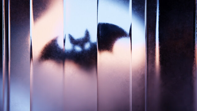 Halloween bat silhouette distorted through vertical transparent glass.