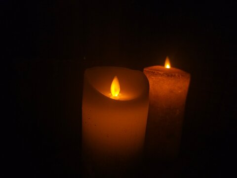 Candles lit in the dark create a warm and inviting glow during