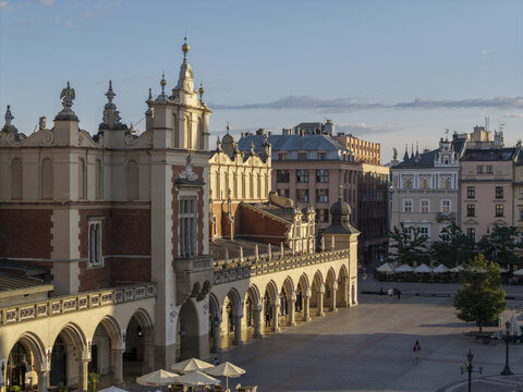 Krakow, Poland - 31 August 2026: Aerial view of the historic Sukiennice Cloth Hall in the Main Market Square, featuring Renaissance architecture, arched loggias, and surrounding urban buildings.