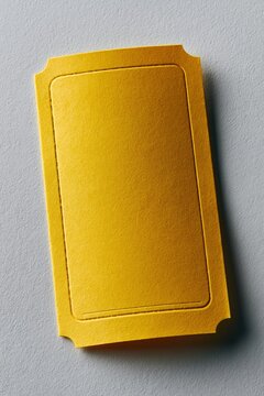 Yellow embossed ticket card with decorative corner notches and inner debossed frame for mockup background and invitation layout