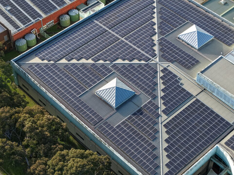 Wantirna South, Australia - 03 September 2026: Aerial view of the Knox Data Centre featuring extensive solar panel arrays covering the rooftop, skylights, and surrounding trees.