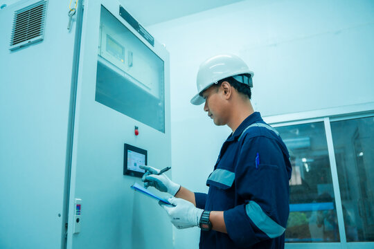 Electrical engineer checklist report control panel continues emission monitoring system. Technician digital screen management analysis air pollution reduction, energy saving. Environment sustainable.