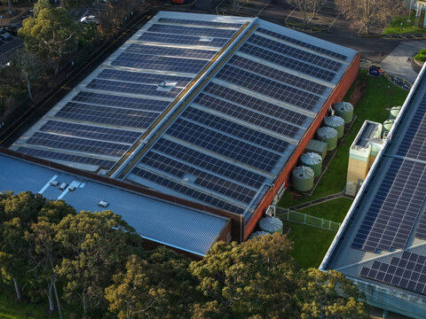 Wantirna South, Victoria, Australia - 03 September 2026: Aerial view of Knox Data Centre with a large solar panel array on the roof, surrounded by trees and water tanks.