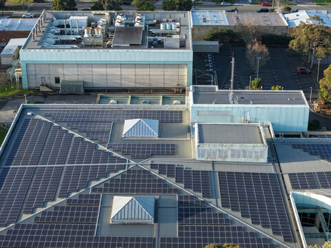 Wantirna South, Australia - 03 September 2026: Aerial view of Knox Data Centre featuring extensive solar panel arrays on the rooftop, industrial cooling units, and surrounding parking areas.