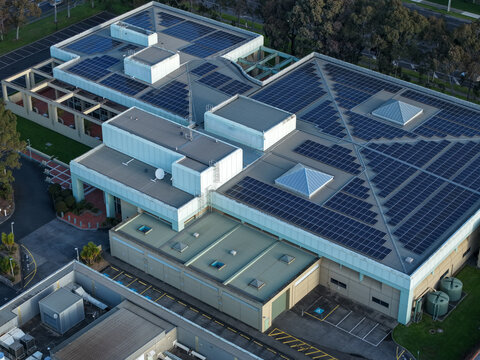 Wantirna South, Victoria, Australia - 03 September 2026: Aerial view of Knox Data Centre with extensive solar panel arrays on its flat roof, surrounded by parking and landscaping.