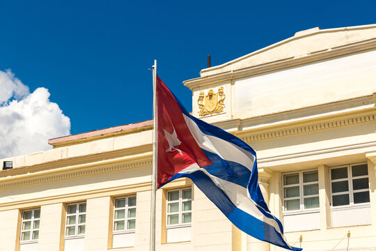 Cuban National Flag Waving in Front of Historic Building