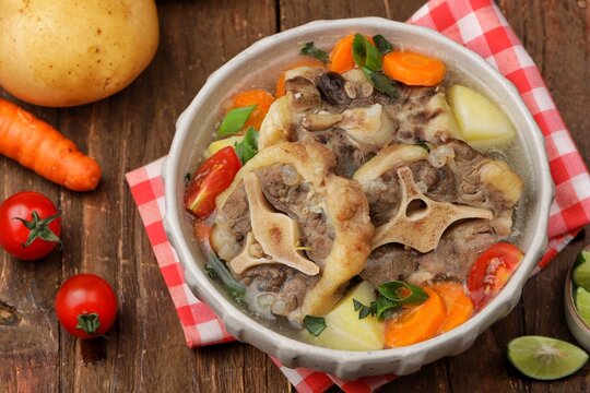 Sop buntut or oxtail soup, a traditional Indonesian oxtail soup made with tender beef oxtail simmered in a rich and flavorful broth with vegetables and aromatic spices..ribs soup