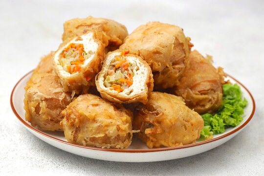 Tahu isi is a popular Indonesian fried snack made from tofu stuffed with seasoned vegetables, such as cabbage, carrots, and bean sprouts, then coated in crispy batter and deep-fried until golden brown