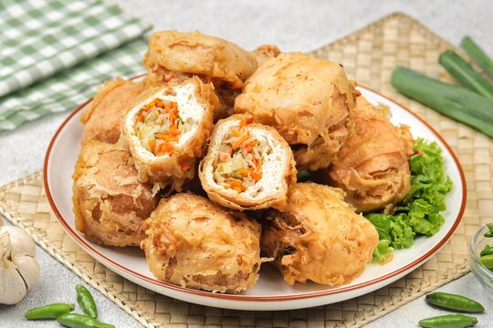 Tahu isi is a popular Indonesian fried snack made from tofu stuffed with seasoned vegetables, such as cabbage, carrots, and bean sprouts, then coated in crispy batter and deep-fried until golden brown