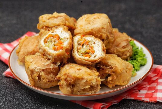 Tahu isi is a popular Indonesian fried snack made from tofu stuffed with seasoned vegetables, such as cabbage, carrots, and bean sprouts, then coated in crispy batter and deep-fried until golden brown