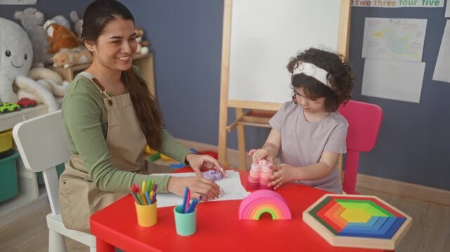 Teacher guiding child stacking colorful toys and pencils at a preschool building; nurturing learning development.