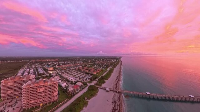 Travel and Nature: 4K Aerial Drone View of a Spectacular Sunrise Over the Atlantic Ocean and Juno Beach Pier, Florida