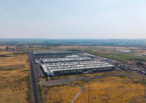 Umatilla, Oregon, United States - 15 August 2026: Aerial view of the Amazon Web Services data center complex surrounded by dry fields under a clear sky.