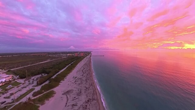 Travel and Nature: 4K Aerial Drone View of a Spectacular Sunrise Over the Atlantic Ocean and Juno Beach Pier, Florida