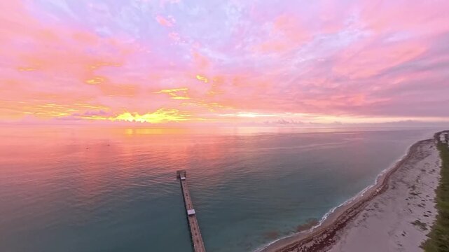 Travel and Nature: 4K Aerial Drone View of a Spectacular Sunrise Over the Atlantic Ocean and Juno Beach Pier, Florida