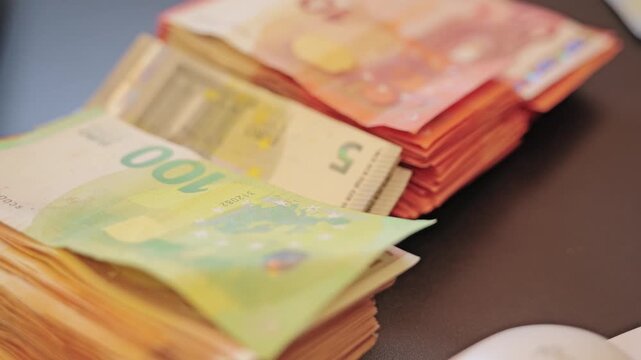 Stack of euro banknotes on office table illustrating financial wealth and business success.