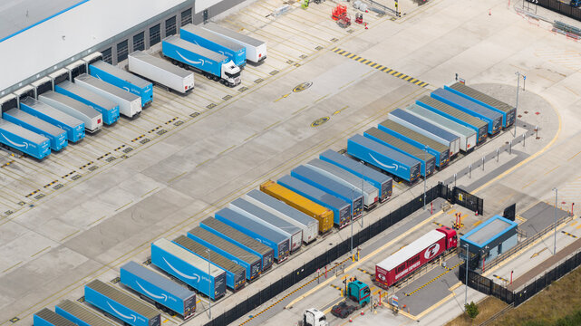 Loversall, United Kingdom - 14 July 2026: Aerial view of the iPort Doncaster logistics facility featuring rows of Amazon Prime semi-trailers parked at loading bays in a large concrete yard.