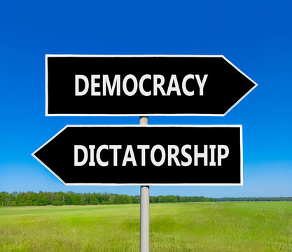 Democracy or dictatorship words symbol. Concept words Democracy Dictatorship on beautiful black road sign. Beautiful blue sky background. Business democracy dictatorship concept. Copy space