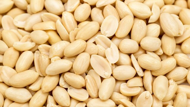 Close up of peeled blanched peanuts background