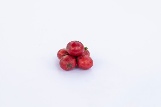Liberica coffee (Coffea Liberica) on a white background, raw coffee. Large red Liberica coffee.