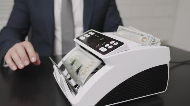Electronic money counter machine counting dollar banknote. Finance and business. Bank officer counting dollar with electronic machine at bank office. Businessman use bill counter, economy