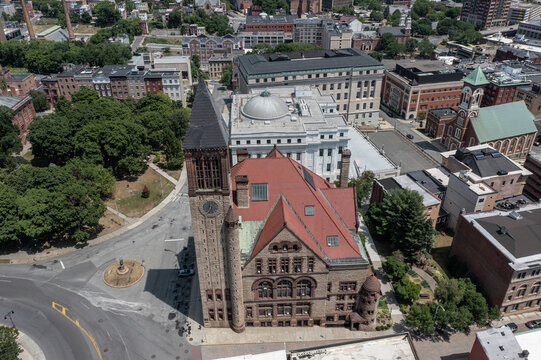 Albany, New York, United States - 24 July 2022: Aerial view of Albany City Hall, a historic Romanesque Revival building with a clock tower and red roof.