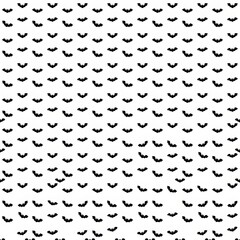 Obraz premium Seamless Halloween pattern with black bat silhouettes on a white background.