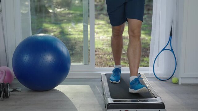 Sportsman running on treadmill in gym. Treadmill workout in fitness gym. Exercise cardio. Sport man legs do sport. Sportsman has cardio workout to burn calories. Sneakers walking