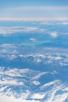 View of the snow-capped peaks and glaciers of Parque Nacional Los Glaciares in the Andes with a turquoise glacial lake, Lago Argentino Department, Santa Cruz Province, Argentina.