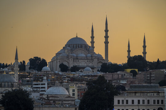 View of the Suleymaniye Mosque with its iconic minarets and domes illuminated by the warm light of the golden hour in Istanbul, Istanbul, Turkiye.