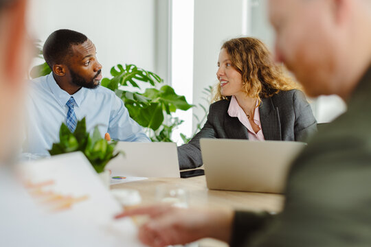 Businesspeople discuss a project during a meeting at the office
