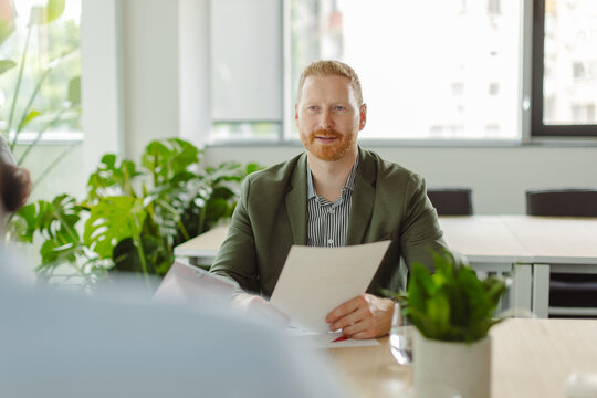 Businessman holds document during office meeting