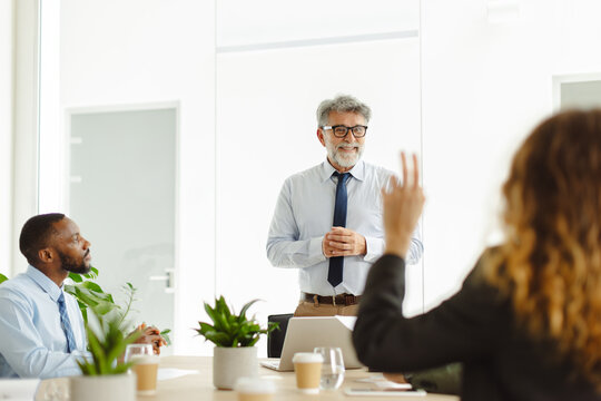 Businesswoman asks a question during a corporate office meeting