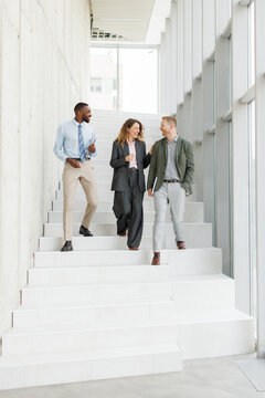 Business colleagues walking down office stairs during a discussion