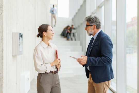 Businessman and businesswoman discuss a problem in a modern office