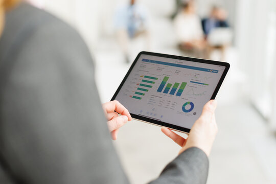 Businesswoman analyzing financial chart on digital tablet at office