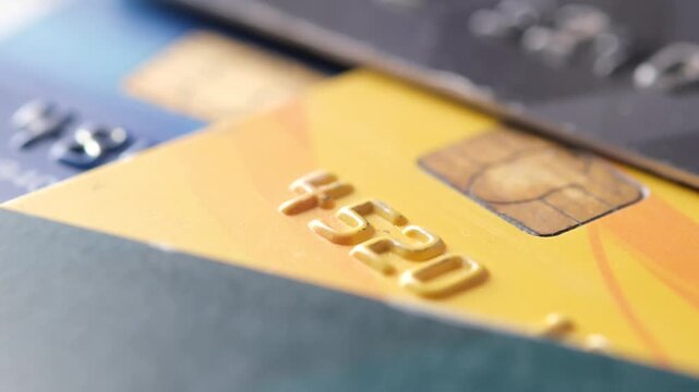 Extreme close up on embossed numbers and chip of credit cards with shallow depth of field
