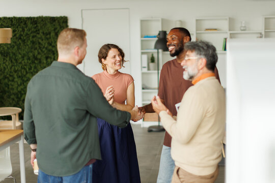 A businessman shakes hands for a deal in the coworking office