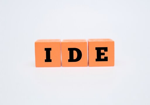 A coloured block with text IDE. IDE acronym for "INTEGRATED DEVELOPMENT ENVIRONMENT". Concept for software, coding, and tech