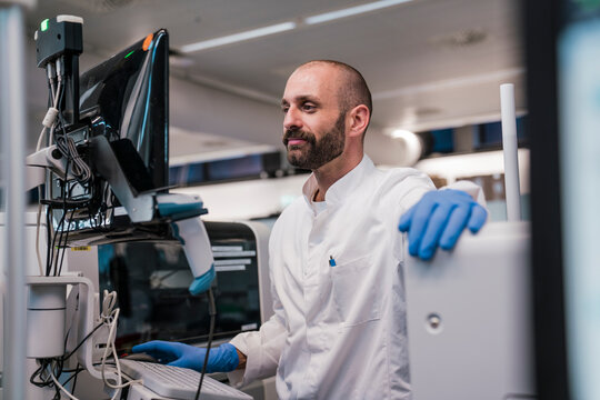 Scientist analyses data on a computer in a high tech laboratory