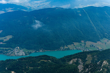 Obraz premium Misty landscape with mountain lake in nature. Mountain peak aerial view. Aerial misty landscape. Scenic nature over lake. Scenic mountain lake. Aerial view of mountain landscape. Landscape panorama