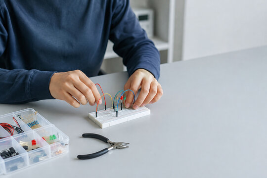 Student Building Electronic Circuit on Breadboard