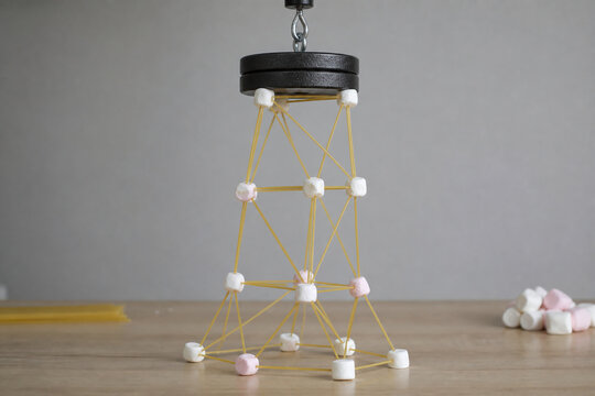 Spaghetti marshmallow tower under weight test