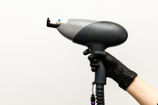 Aesthetic Laser Treatments concept. Doctor hand with laser device, white background. Innovative non-ablative fractional technology for skin rejuvenation. Cellular renewal, active collagen synthesis