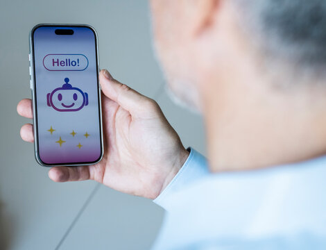 Businessman holds smartphone with AI chatbot at the office