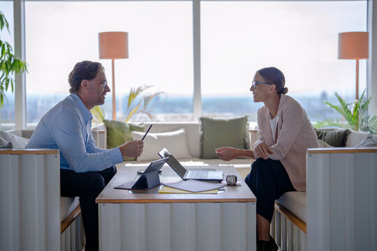 Businessman and businesswoman discuss strategy in the office