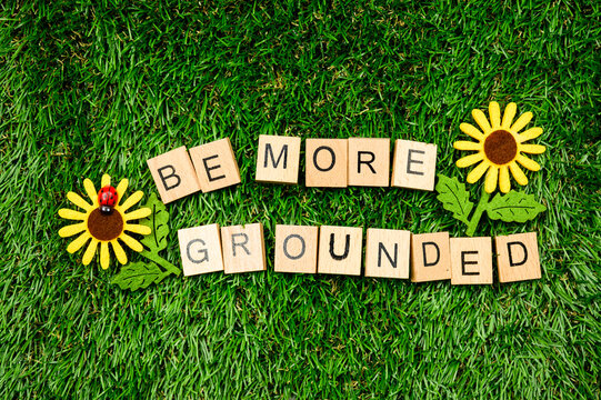 Be more grounded sign on grass