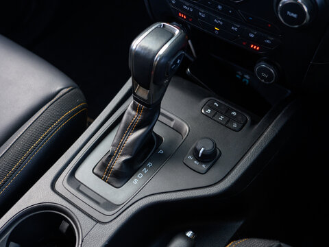 Modern car interior shows gear shift knob