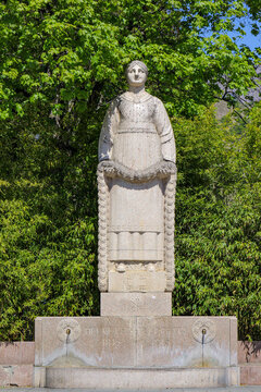 Sion, Switzerland - April 30. 2017: Statue of St. Catherine, (also known as the monument for the centenary of Valais joining the Swiss Confederation) on the Place de la Planta, Sion, Switzerland